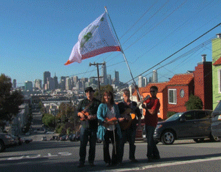 Fret & Fiddle wave their flag outside the garden in San Francisco